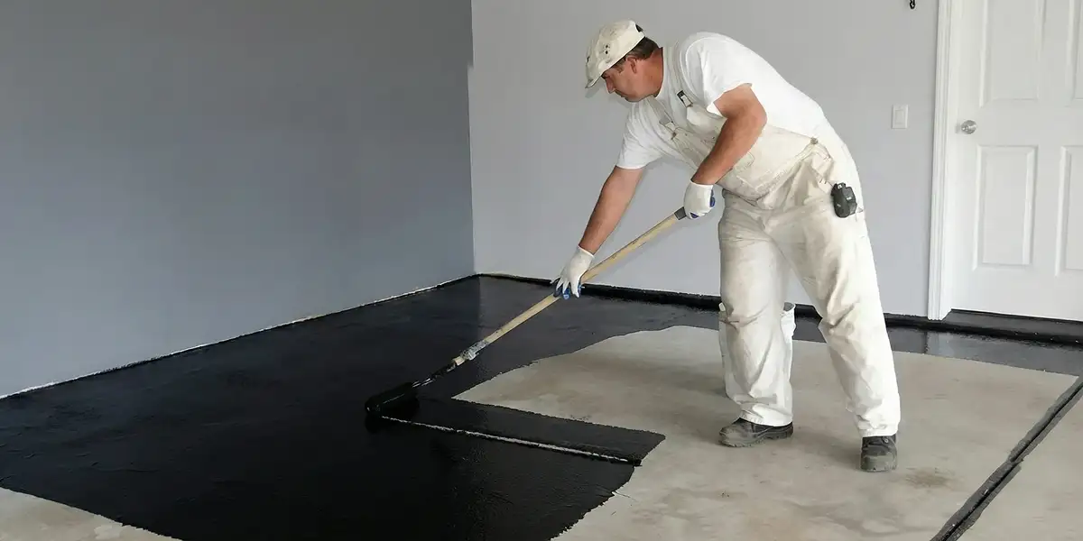 basement waterproofing professional applying waterproof coating to protect a basement floor in Clearwater, FL