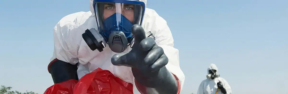 sewage clean up technician wearing protective gear handling biohazard materials in Clearwater, FL